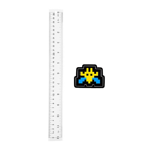 invader blue and yellow invader sticker shown next to ruler for scale