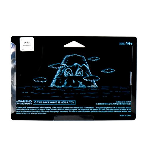 kaws holiday japan vinyl figure in black in sealed package from back