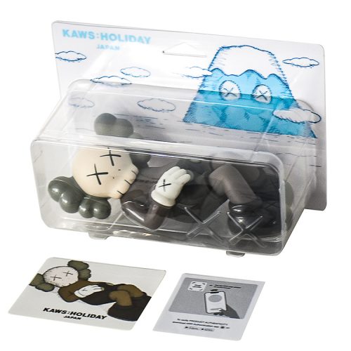 kaws holiday japan vinyl figure in brown sealed package shown with info cards