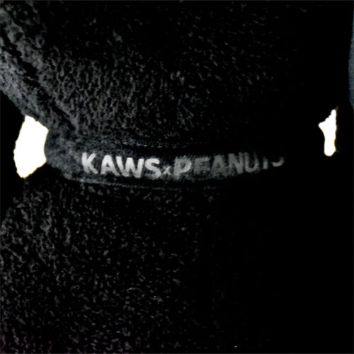 kaws black snoopy showing tag with kaws x peanuts