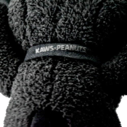 kaws uniqlo snoopy plush black small showing close up of kaws tag on neck collar