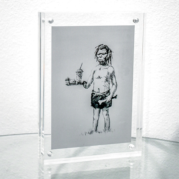 banksy more seating upstairs postcard in a clear block frame