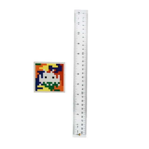 invader rubik camo 3 sticker shown next to ruler for scale