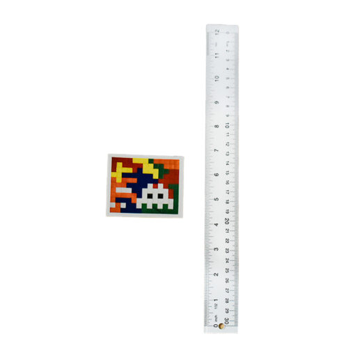 invader rubik space camo sticker next to ruler for scale