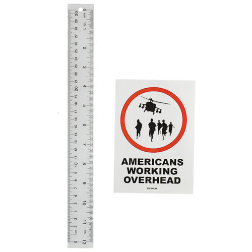 banksy americans working overhead sticker next to ruler