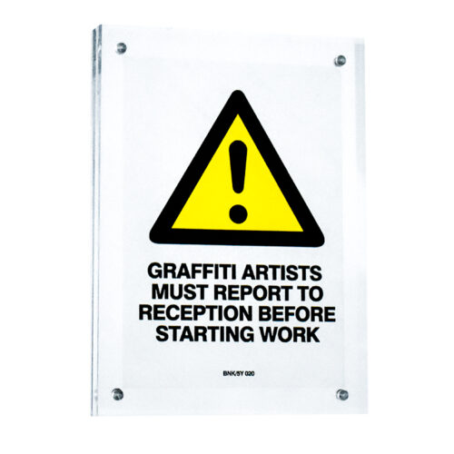 banksy graffiti artists must report to reception sticker in clear frame