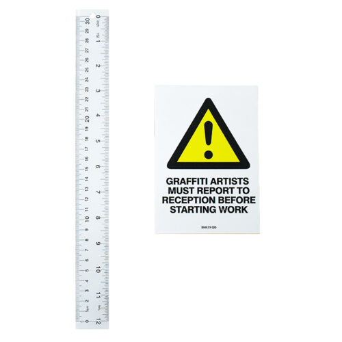 banksy graffiti artists must report to reception sticker next to ruler