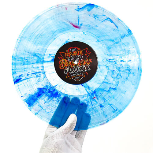 person holding blue faile bast deluxx fluxx record