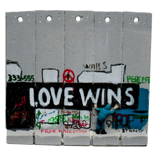 close up of banksy walled off hotel love wins wall sculpture