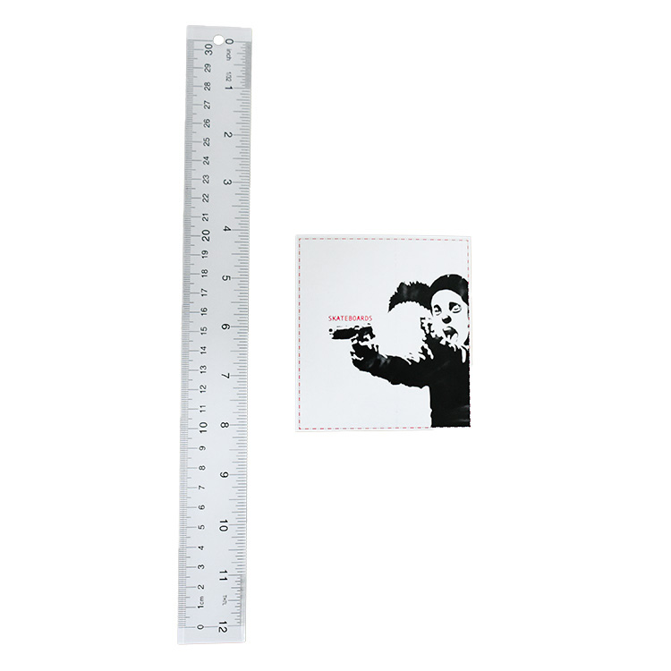 banksy clown skateboards logo sticker next to ruler for scale