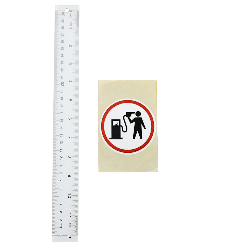 banksy petrolhead round sticker next to ruler