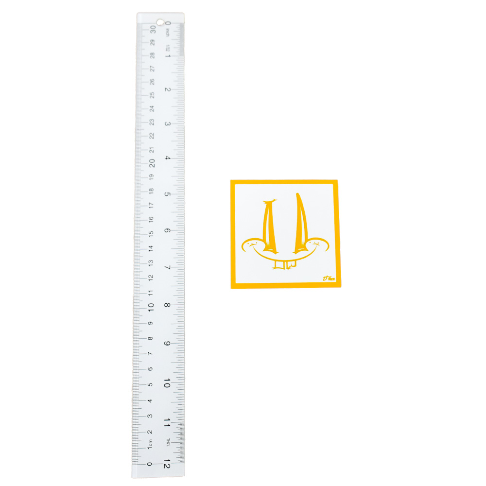 dface smiley face sticker yellow next to ruler