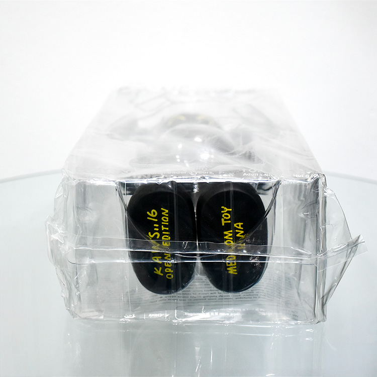 bottom foot of kaws companion figure in black from 2016 showing stamp