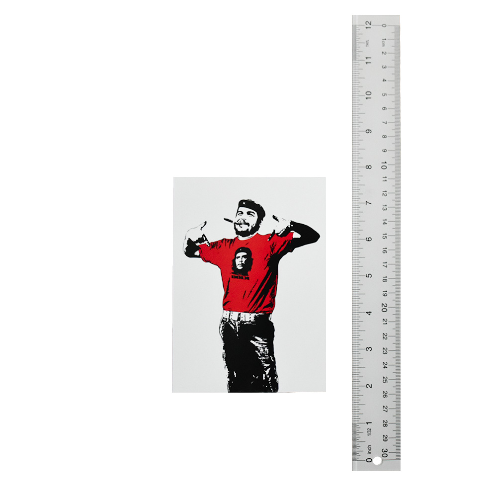 dolk che pow postcard next to ruler for scale